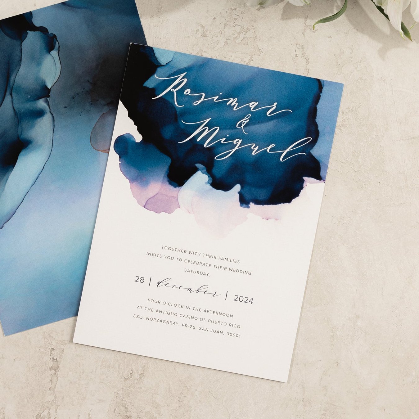 Abstract ocean-inspired watercolor wedding invitation close-up with customizable ombre watercolor background in soft blues and sea tones.