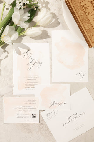 Minimal and romantic wedding invitation suite with a subtle ombre watercolor design in delicate, soft tones.