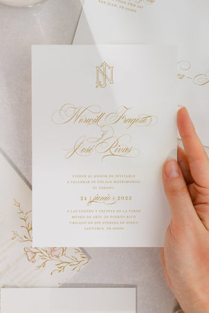 Luxurious wedding invitation card with a regal monogram and handmade floral watercolor illustrations, complemented by a vellum gate.