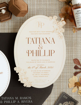 Wedding invitation card for Tatiana & Phillip with decorative elements on a textured surface.