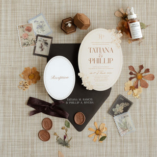 Wedding invitation set with floral elements on a textured surface